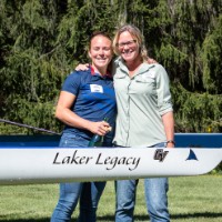 GVSU mother and daughter alumni Mandy Boersen and Audrey Boersen hugging behind boat that says Laker Legacy